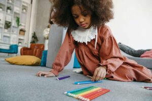 A child playing with color pencils.