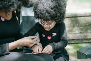 A Child With Sensory Disorder Playing With Stickers.