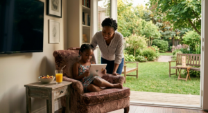 Mother monitoring her daughter's screen time to support sensory regulation